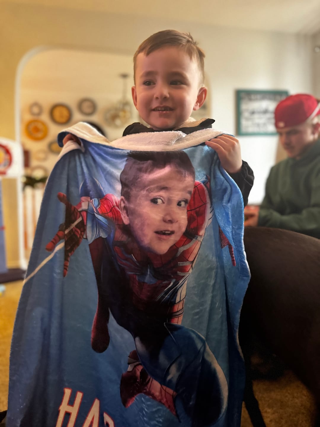 Boy holding Spiderman Blanket with face and name