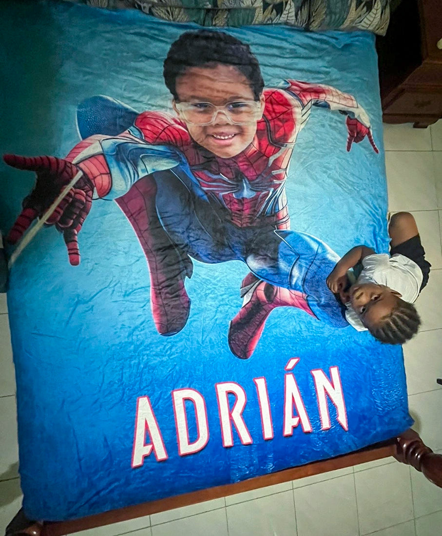 kid with his Spiderman blanket on a bed