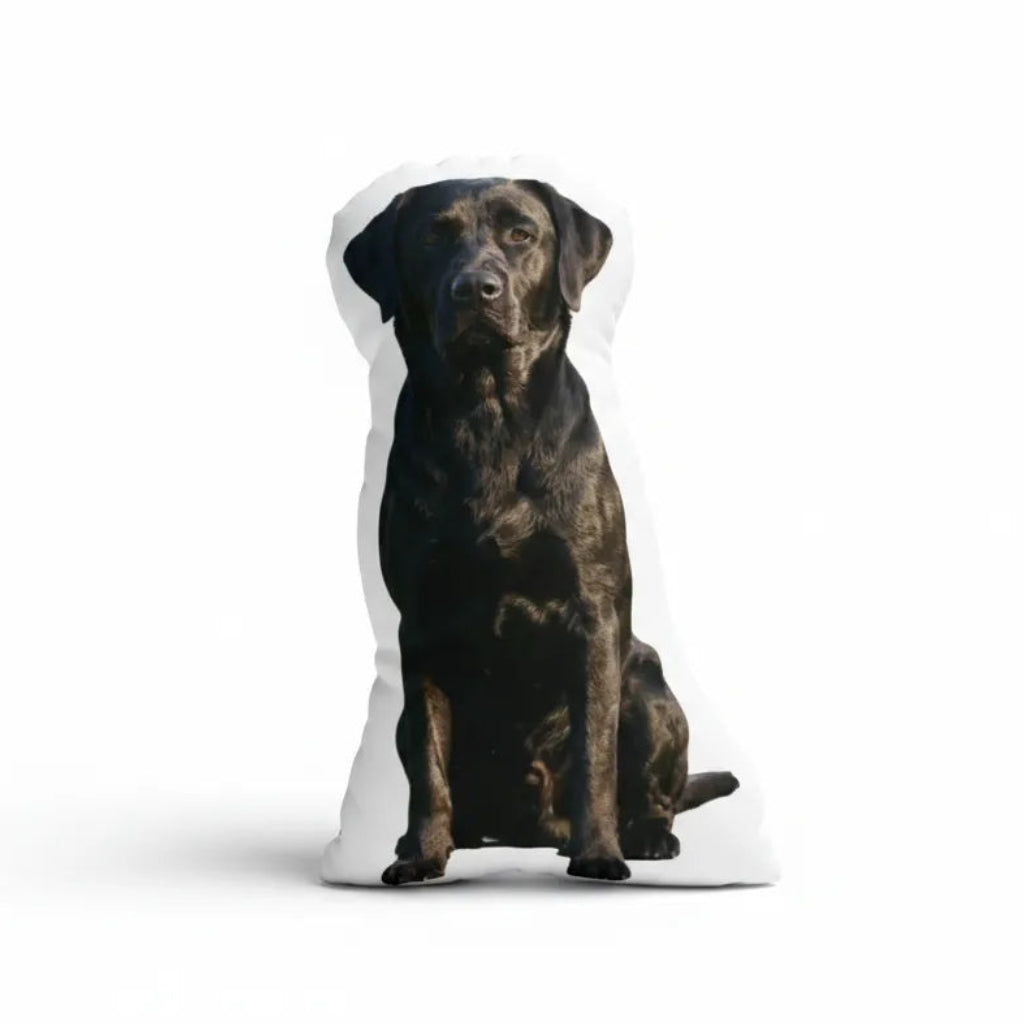 Dog-shaped pillow with a black dog design on a white background
