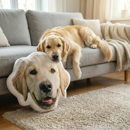 Dog lying on a couch with a pillow shaped like its face in a living room.